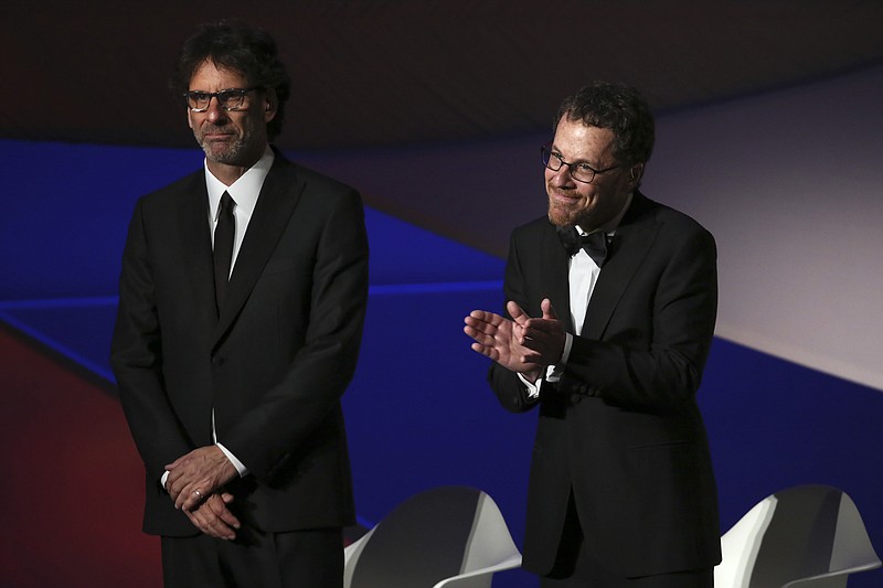 
              File-This May 13, 2015, file photo shows Jury presidents Ethan Coen, right, and Joel Coen standing on stage during the opening ceremony at the 68th international film festival, Cannes, southern France.  The Coen will polish the script for a planned “Scarface” remake. Universal Pictures announced Friday, Feb. 10, 2017, that “an explosive reimagining” of the gangster classic will be released in August 2018. Diego Luna is set to star in the role famously played by Al Pacino in Brian De Palma’s 1983 remake of the 1932 original.(Photo by Joel Ryan/Invision/AP, File)
            