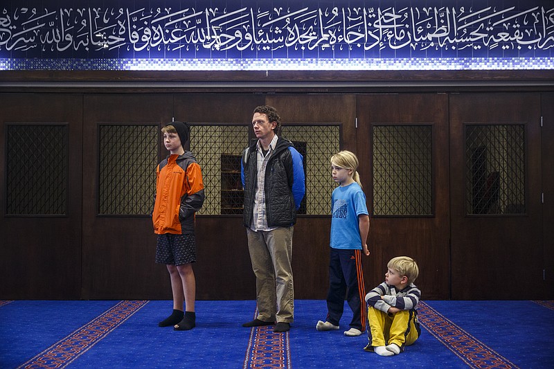 Liam Carpenter, Kevin Carpenter, Jude Carpenter, and Rory Carpenter, from left, watch an afternoon prayer at a Meet Your Muslim Neighbor event held at the Islamic Center of Greater Chattanooga on Saturday, Feb. 11, 2017, in Chattanooga, Tenn. The center opened its doors to guests to educate them about Islam and to give tours of the center.