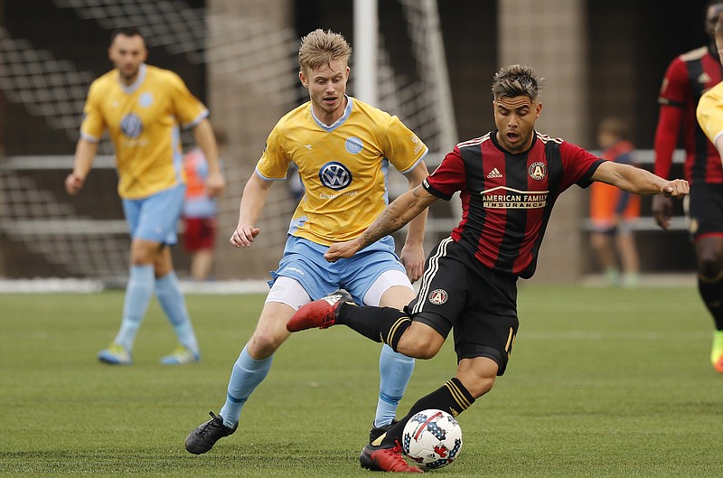 AUFC's Hector Villalba, right, dribbles ahead of CFC's Sindre Willo during Chattanooga FC's friendly match against Atlanta United FC at Finely Stadium on Saturday, Feb. 11, 2017, in Chattanooga, Tenn.