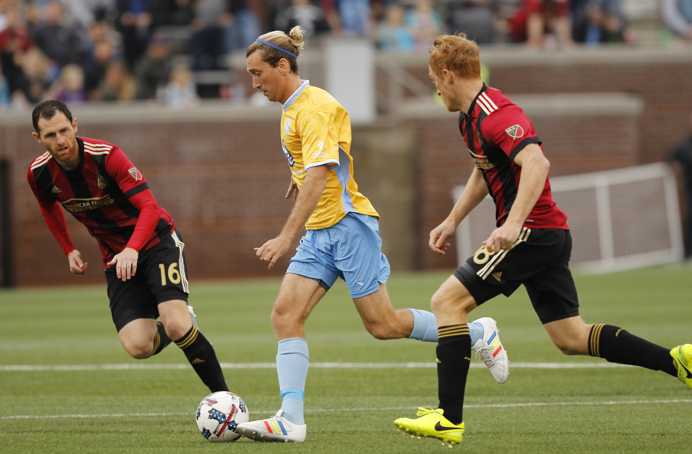 CFC's Juan Hernandez, center, dribbles between AUFC's Chris McCann, left, and Jeff Larentowicz during Chattanooga FC's friendly match against Atlanta United FC at Finely Stadium on Saturday, Feb. 11, 2017, in Chattanooga, Tenn.