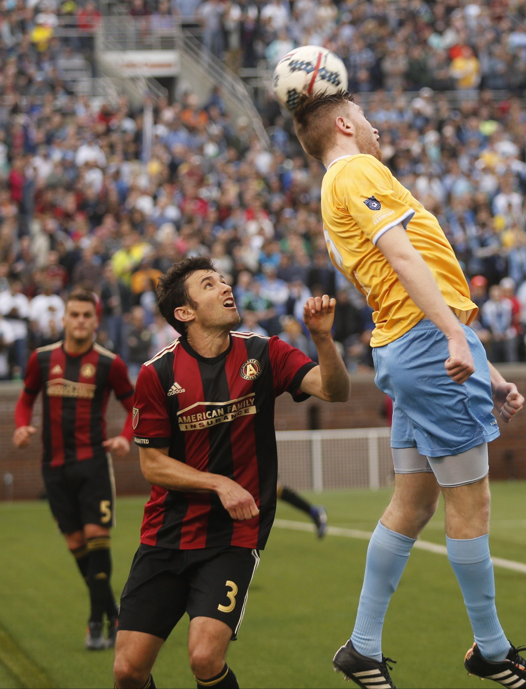 CFC's Danny Whitehall, right, heads the ball over AUFC's Michael Parkhurst during Chattanooga FC's friendly match against Atlanta United FC at Finely Stadium on Saturday, Feb. 11, 2017, in Chattanooga, Tenn.