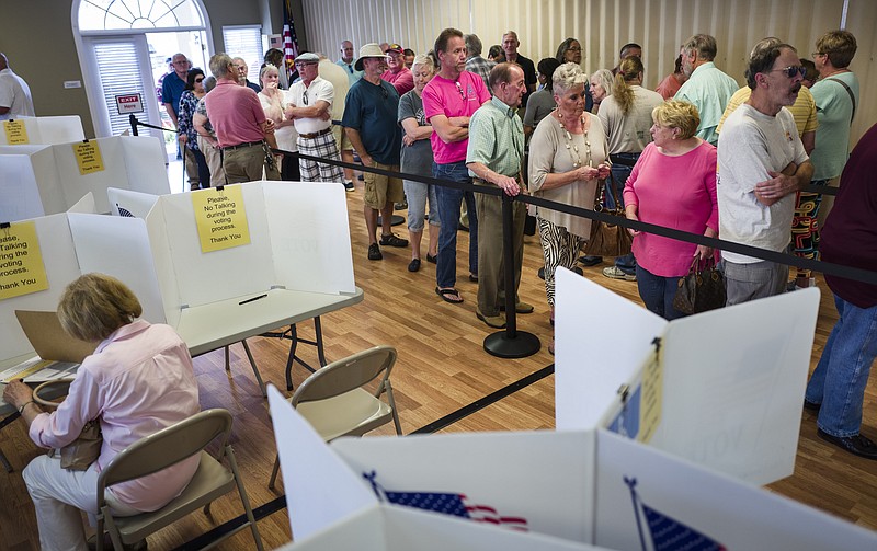 Voters wait in line to cast their ballots on the first day of early voting on Oct. 19, 2016, at the North River Civic Center.
