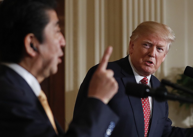 
              President Donald Trump listens Japanese Prime Minister Shinzo Abe speaks during a joint new conference in the East Room of the White House, in Washington, Friday, Feb. 10, 2017. (AP Photo/Carolyn Kaster)
            
