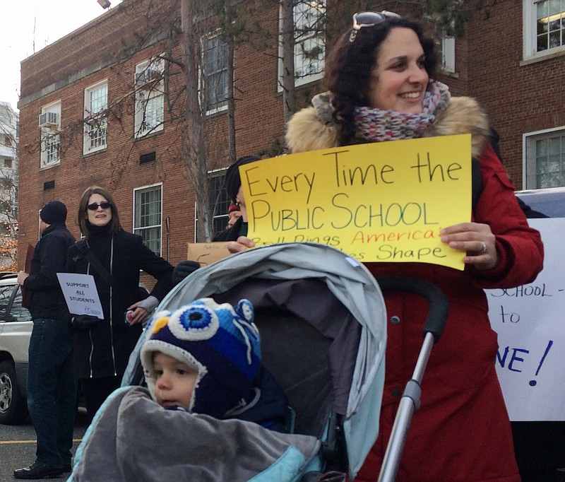
              Jennifer Ibrahim participates in a demonstration outside Jefferson Middle School in Washington, Friday, Feb. 10, 2017, as Education Secretary Betsy DeVos paid her first visit as education secretary in a bid to mend fences with educators after a bruising confirmation battle. (AP Photo/Maria Danilova)
            