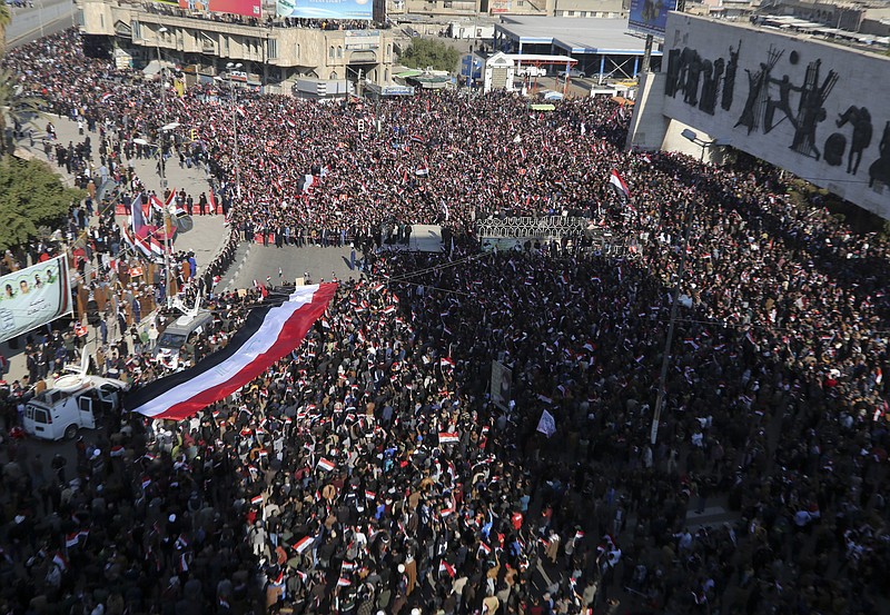 
              Followers of Iraq's influential Shiite cleric Muqtada al-Sadr chant slogans as they wave national flags during a demonstration against corruption in Baghdad, Iraq, Saturday, Feb. 11, 2017. (AP Photo/ Karim Kadim)
            