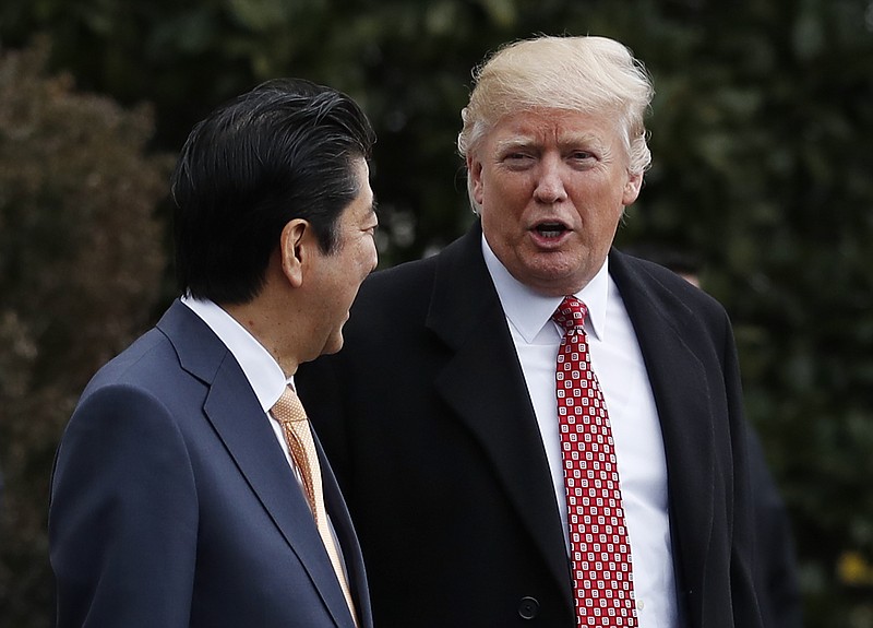 
              President Donald Trump talks to Japanese Prime Minister Shinzo Abe as they walk to board Marine One on the South Lawn of the White House in Washington, Friday, Feb. 10, 2017, for the short trip to Andrews Air Force Base, Md. en route to West Palm Beach, Fla. (AP Photo/Carolyn Kaster)
            