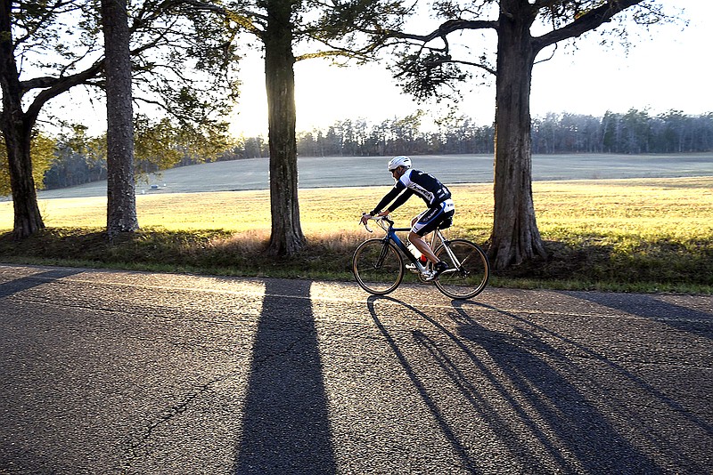 Staff file photo by Robin Rudd / A cyclist casts long evening shadows as rides along the Dyer Field in Chickamauga National Military Park in 2015.