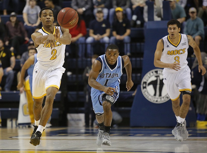 UTC guard Rodney Chatman, left, passes the ball ahead of teammate Nat Dixon, right, and Citadel guard Frankie Johnson during the Mocs' home basketball game against The Citadel at McKenzie Arena on Wednesday, Jan. 11, 2017, in Chattanooga, Tenn.