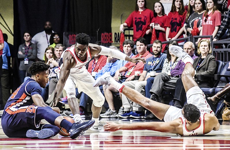 Auburn forward Anfernee McLemore (24), Mississippi guard Terence Davis (3), and Mississippi forward Sebastian Saiz (11) go for the ball during an NCAA college basketball game in Oxford, Miss., Saturday, Feb. 11, 2017. (Bruce Newman/The Oxford Eagle via AP)