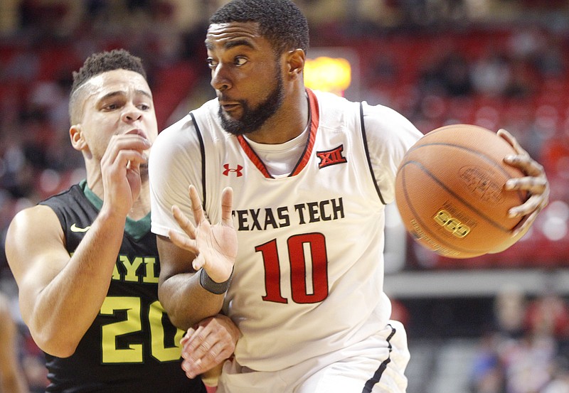 
              Texas Tech guard Niem Stevenson drives around Baylor guard Manu Lecomte during the first period of an NCAA college basketball game Monday, Feb. 13, 2017, in Lubbock, Texas. (AP Photo/Mark Rogers)
            