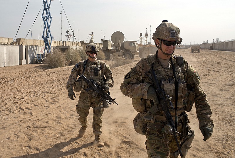 
              FILE - In this Nov. 9, 2016 file photo, U.S. Army soldiers move through Qayara West Coalition base in Qayara, some 50 kilometers south of Mosul, Iraq. Reverberations from President Donald Trump’s travel ban and other stances are threatening to undermine future U.S.-Iraqi security cooperation, rattling a key alliance that over the past two years has slowly beaten back the Islamic State group. Iraq’s prime minister, Haider al-Abadi, has sought to contain public anger sparked by the ban and by Trump’s repeated statements that the Americans should have taken Iraq’s oil, as well as his hard line against Iran, a close ally of Baghdad. (AP Photo/Marko Drobnjakovic, File)
            