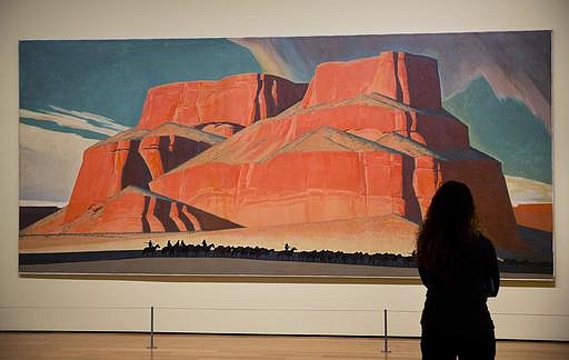 In this Monday, Feb. 6, 2017 photo, Maynard Dixon's 1935 painting "Red Butte with Mountain Men" is displayed in the exhibit "Cross Country: The Power of Place in American Art, 1915-1950," at the High Museum of Art in Atlanta. The new exhibition at takes a look at how American artists during the modernist period traveled outside cities to find inspiration in the rural landscape. (AP Photo/David Goldman)