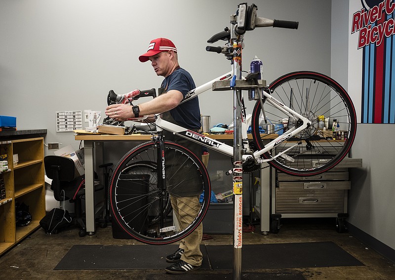 Owner Ronald Driver assembles a bicycle that was purchased by a customer from an online retailer at River City Bicycles on Brainerd Road on Tuesday, Feb. 14, 2017, in Chattanooga, Tenn. The locally-owned bicycle shop will be closing on Feb. 28.