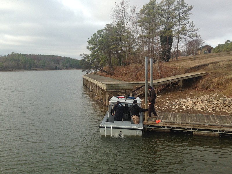 Alabama State Troopers arrive, Wednesday, Dec. 14, 2016,  to search for a missing victim after a vehicle drove off a boat landing Tuesday in northeastern Alabama at Leesburg Landing in Cherokee County, Ala. An official says four people are dead and that crews are searching for a fifth person.  (William Thornton/AL.com via AP)