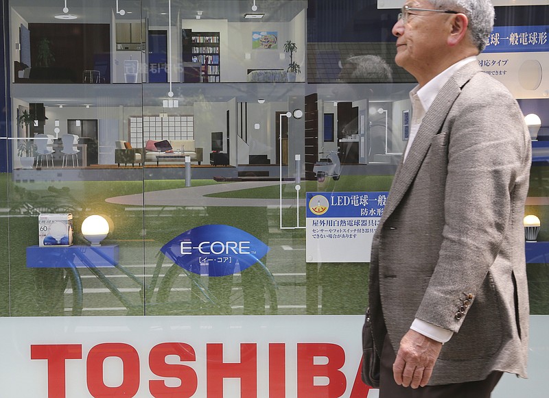 
              In this April 16, 2016 photo, a man walks past a display of Toshiba Corp.'s products in Tokyo. Japanese electronics and energy giant Toshiba delayed reporting its financial results by a month Tuesday, Feb. 14, 2017, citing problems with its auditing. Toshiba stock tumbled 8 percent in Tokyo trading after its earnings weren't announced as scheduled. The company said the earnings won't be out until March 14. Auditors had questioned Toshiba's reporting on the acquisition of CB&I Stone & Webster by its U.S. nuclear unit Westinghouse, the company said in a statement. (AP Photo/Koji Sasahara)
            