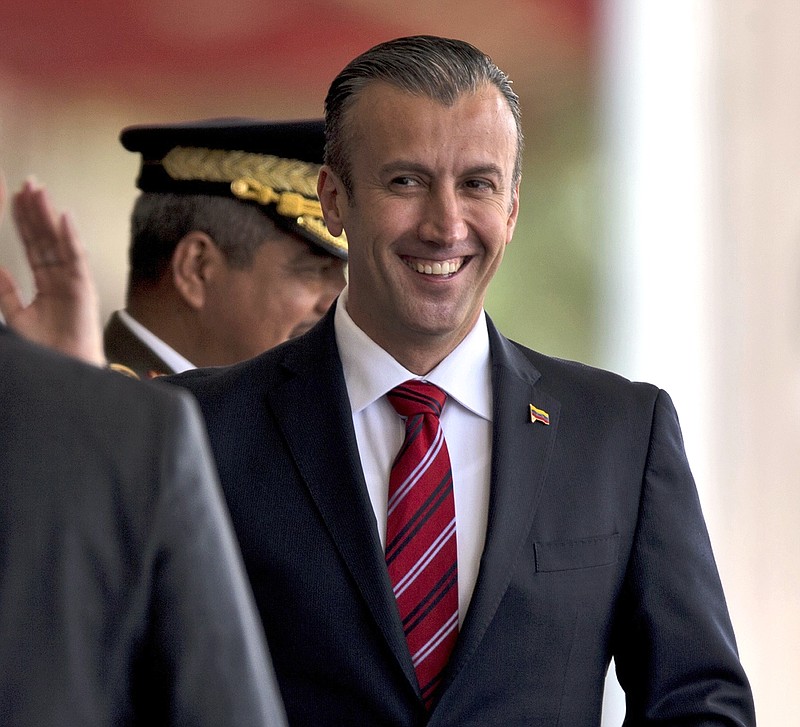 
              FILE - In this Feb. 1, 2017 photo, Venezuela's Vice President Tareck El Aissami, right, is saluted by Boilivarian Army officer upon his arrival for a military parade at Fort Tiuna in Caracas, Venezuela. The administration of President Donald Trump is slapping sanctions on El Aissami and accusing him of playing a major role in international drug trafficking. That’s according to individuals briefed on the U.S. government’s plans who requested anonymity to disclose the move ahead of a formal announcement. (AP Photo/Fernando Llano)
            