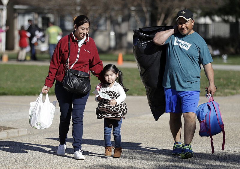 
              Catalina Rosales, from left, her daughter Kelly, 3, and husband Armando, of Gridley, Calif., leave a shelter after a mandatory evacuation was lifted Tuesday, Feb. 14, 2017, in Chico, Calif. Authorities lifted an evacuation order Tuesday for thousands of California residents who live below the nation's tallest dam after declaring that the risk of catastrophic collapse of a damaged spillway had been significantly reduced. (AP Photo/Marcio Jose Sanchez)
            