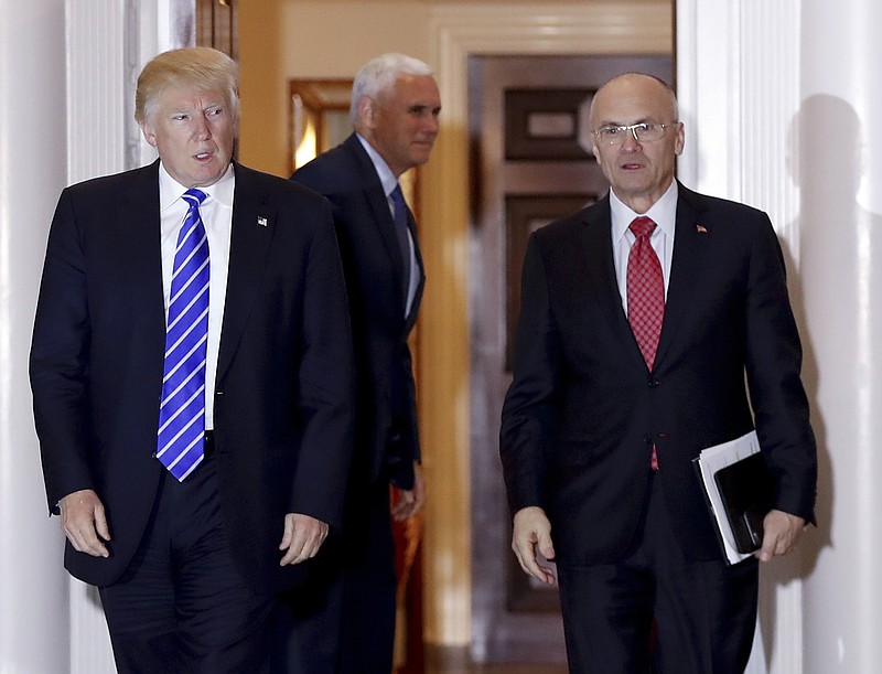 In this Nov. 19, 2016, file photo, then-President-elect Donald Trump walks Labor Secretary-designate Andrew Puzder from Trump National Golf Club Bedminster clubhouse in Bedminster, N.J. Four Republicans on the Senate committee considering President Donald Trump's nominee for secretary of labor aren't saying publicly if they will vote for him. (AP Photo/Carolyn Kaster, File)