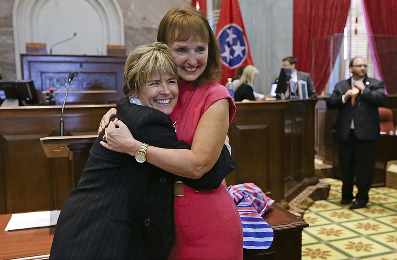  In an April 17, 2014, file photo, Rep. Terri Lynn Weaver, left, R-Lancaster, hugs House Speaker Beth Harwell, R-Nashville, right, on the final day of the 108th General Assembly in Nashville, Tenn. Gay rights advocates are raising the alarm about a Tennessee bill sponsored by Weaver they say could make it impossible for same-sex couples to be recognized as the legal parents of children. The bill would repeal a 1977 state law that declared children born as a result of artificial insemination to be the legitimate offspring of the husband and wife. (AP Photo/Mark Humphrey, File)