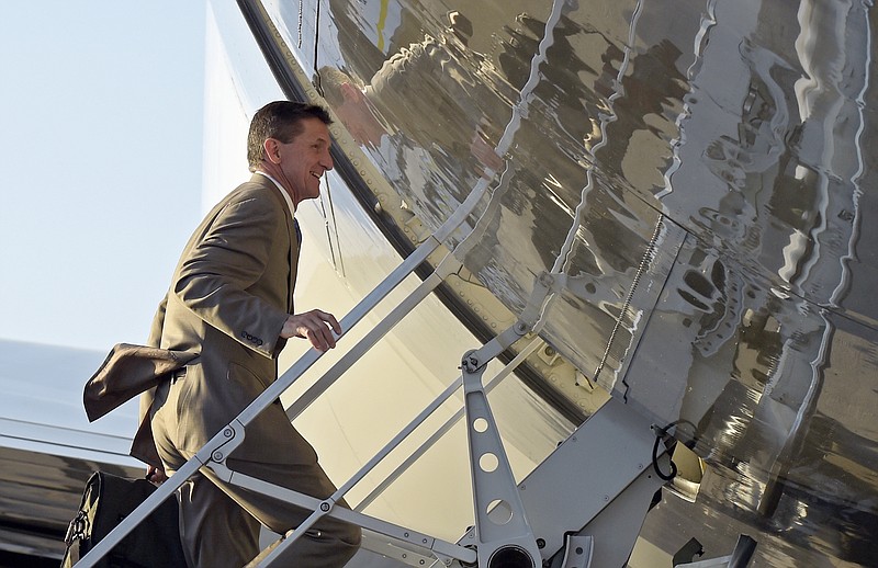 In this Feb. 12, 2017, photo, National Security Adviser Michael Flynn boards Air Force One at Palm Beach International Airport in West Palm Beach, Fla., as he return to Washington with President Donald Trump. Flynn resigned as President Donald Trump's national security adviser Monday, Feb. 13, 2017. (AP Photo/Susan Walsh)