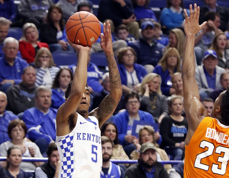 Kentucky's Malik Monk takes a three point shot under pressure from Tennessee's Jordan Bowden (23) during the first half of an NCAA college basketball game, Tuesday, Feb. 14, 2017, in Lexington, Ky. (AP Photo/James Crisp)