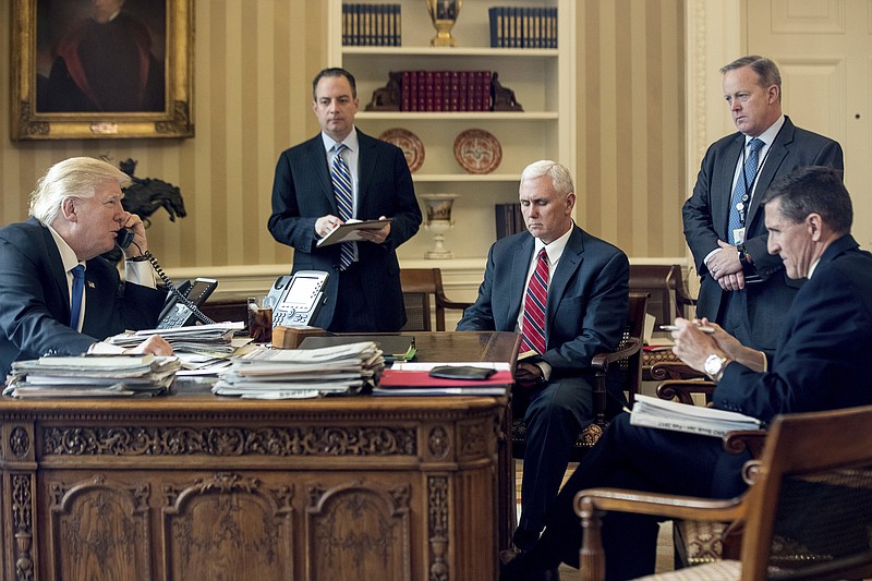 
              FILE - In this Jan. 28, 2017, file photo, President Donald Trump accompanied by, from second from left, Chief of Staff Reince Priebus, Vice President Mike Pence, White House press secretary Sean Spicer and National Security Adviser Michael Flynn speaks on the phone with Russian President Vladimir Putin in the Oval Office at the White House in Washington. Flynn resigned as President Donald Trump's national security adviser Monday, Feb. 13, 2017. (AP Photo/Andrew Harnik, File)
            