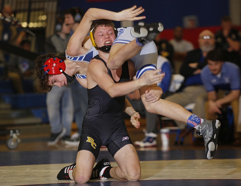 Bradley Central's T.J. Hicks lifts Cleveland's Garrett Bowers during the 113 lb bout of their prep wrestling meet at Cleveland High School on Thursday, Jan. 12, 2017, in Cleveland, Tenn.