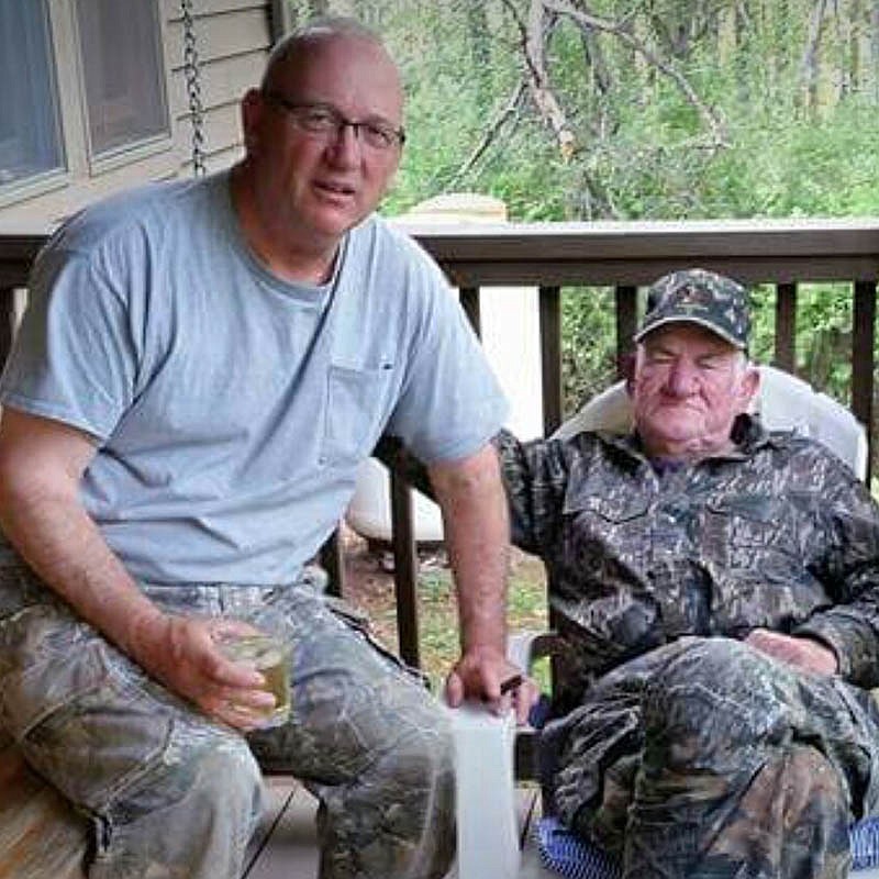 Turkey hunting buddies and fellow former game wardens Larry Case, left, and George Lee Dooley, right, share a relaxing moment on the back porch of their camp at Bluestone in West Virginia. Case remembers Dooley, who died last month, as the master of ceremonies for any hunting party.