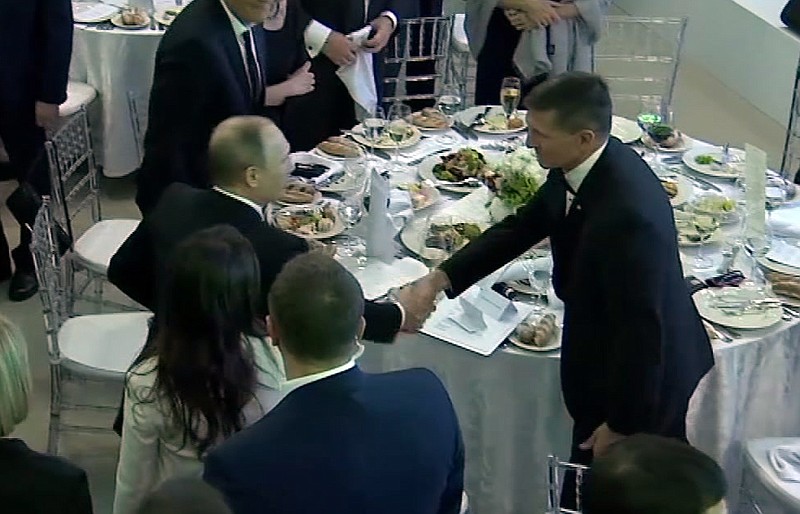 
              In this image made from a video taken on Dec. 10, 2015 and made available on Tuesday, Feb. 14, 2017, US President Donald Trump's former National Security Advisor Michael Flynn, right, shakes hands with Russian President Vladimir Putin, in Moscow. Flynn, who resigned following reports that he misled White House officials about his contacts with Russia, was seen attending the 10th anniversary of the Russian television network RT in 2015 where Russian President Vladimir Putin gave a speech. A US official has told The Associated Press that Flynn was in frequent contact with Ambassador Sergey Kislyak on the day the Obama administration imposed sanctions on Russia after US intelligence reported that Russia had interfered with the US elections. (Ruptly via AP)
            
