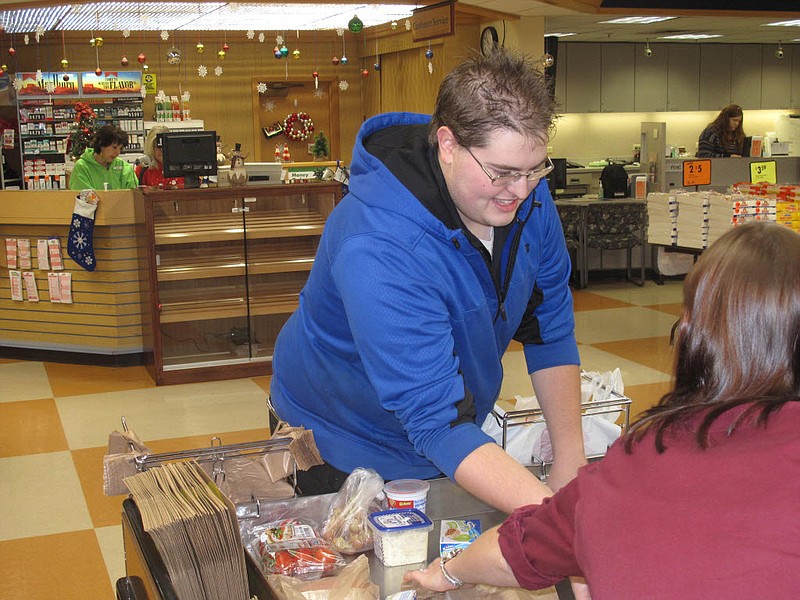 
              In this recent photo, Brady Long, left, bags groceries at Buehler's Fresh Foods at Forest Meadows in Medina, Ohio. Long, a 23-year-old University of Akron accounting student, has been named the nation's top grocery bagger after claiming the Ohio title two years in a row. He competed against nearly two dozen others in the National Grocers Association's Best Bagger championship in Las Vegas. (Bob Finnan/Medina County Gazette via AP)
            