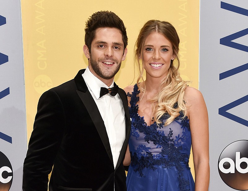 
              FILE - This Nov. 2, 2016 file photo shows Thomas Rhett and his wife Lauren at the 50th annual CMA Awards in Nashville, Tenn. Rhett announced on Twitter Wednesday, Feb. 15, 2017, that his wife is pregnant and that they are also in the process of adopting a child from Africa. (Photo by Evan Agostini/Invision/AP, File)
            