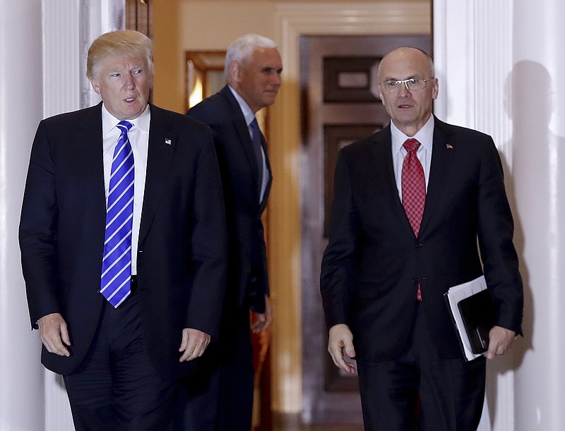 
              FILE - In this Nov. 19, 2016 file photo, then-President-elect Donald Trump walks Labor Secretary-designate Andy Puzder from Trump National Golf Club Bedminster clubhouse in Bedminster, N.J. Puzder’s nomination appeared to be in serious trouble Wednesday, Feb. 15, 2017, as Republicans said they were concerned over his failure to pay taxes for five years on a former housekeeper who wasn’t authorized to work in the U.S.  (AP Photo/Carolyn Kaster, File)
            