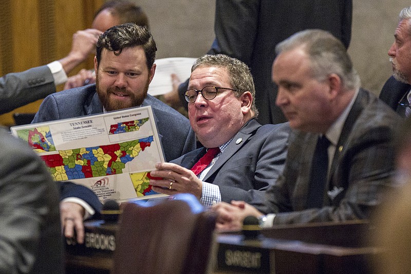
              Rep. Gerald McCormick, R-Chattanooga, center, and Rep. Michael Curcio, R-Dickson, left look at a district map during a House floor session in Nashville, Tenn., on Thursday, Feb. 16, 2017. At right is Rep. Kevin Brooks, R-Cleveland. (AP Photo/Erik Schelzig)
            