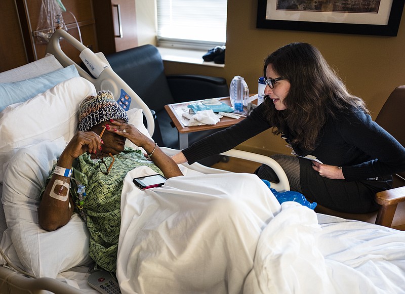 Chaplain Katharine Howe Toledano, right, talks with Gloria Robinson in her room on the oncology ward of Erlanger Medical Center. Toledano ministers to patients and their families of all faiths during their time at the hospital.