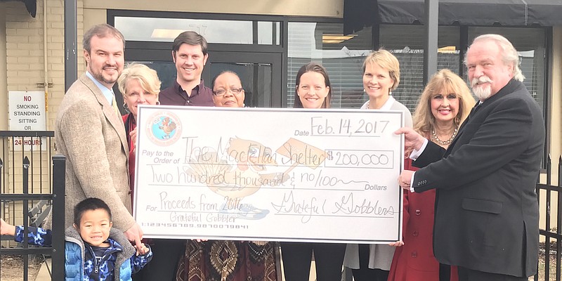 At the Maclellan Shelter check presentation are, from left, Charlie Heald, Maclellan family member; Jens Christensen, Chattanooga Community Kitchen executive director; Betsy McCright, Grateful Gobbler race director; Paul Luikart, director of the Maclellan Shelter for Families; Mellissa McKibbens, from the Maclellan Shelter for Families; and Elizabeth Lindquist, Cathy Heald, Lisa and Scott Maclellan, all Maclellan family members.