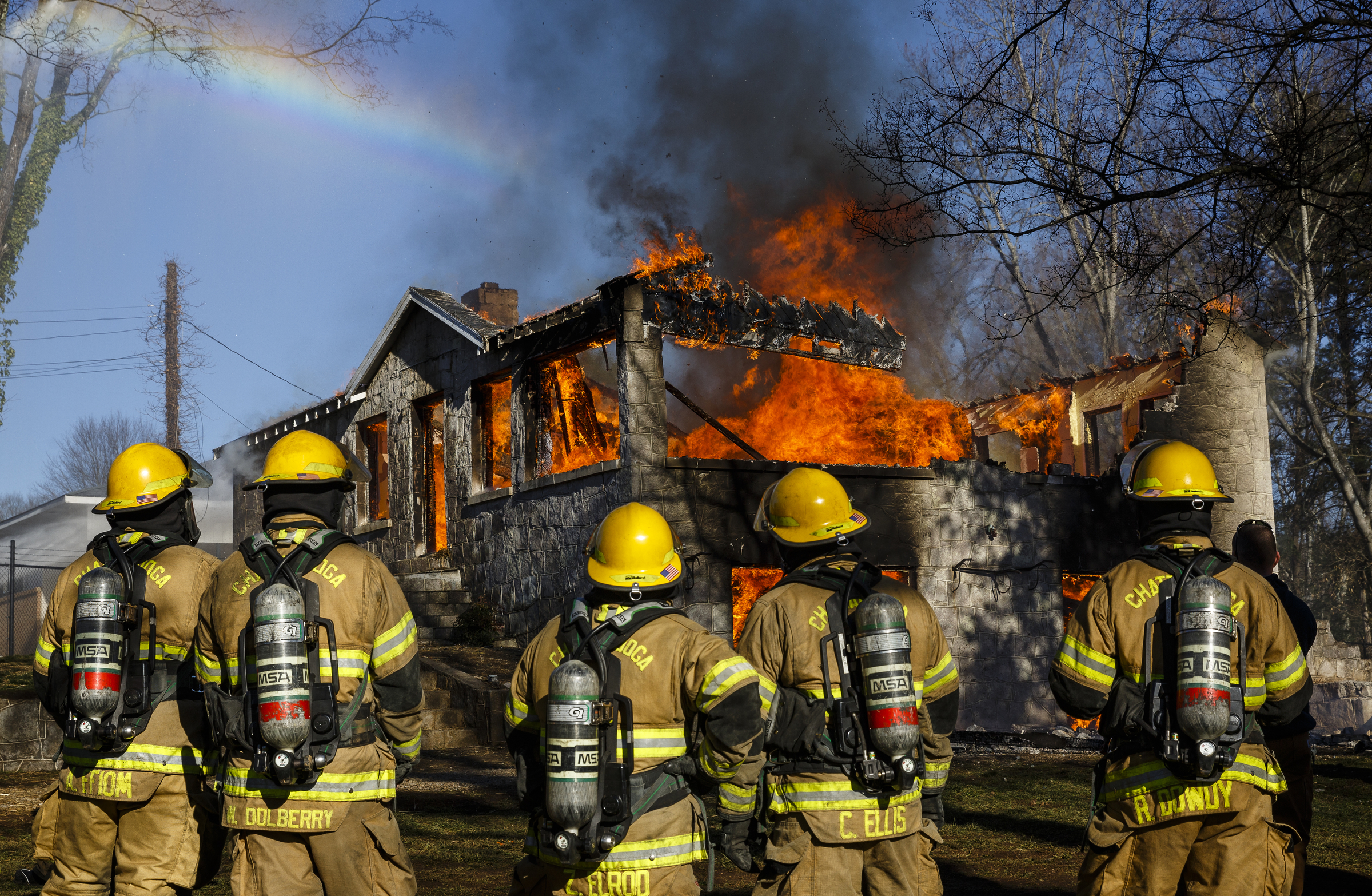 Firefighters watch the structure collapse at a live burn training event by the Chattanooga Fire Department on Robin Drive on Thursday, Feb. 16, 2017, in Chattanooga, Tenn. The fire department uses live burns as part of their fire academy training, culminating in the complete immolation of a structure.