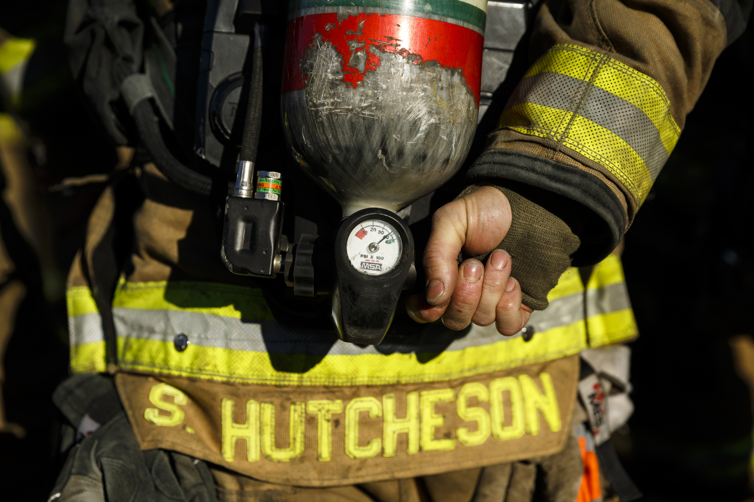 A fire recruit activates his air supply at a live burn training event by the Chattanooga Fire Department on Robin Drive on Thursday, Feb. 16, 2017, in Chattanooga, Tenn. The fire department uses live burns as part of their fire academy training, culminating in the complete immolation of a structure.