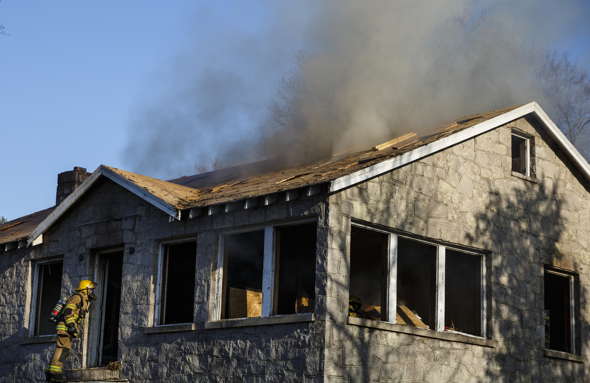 A firefighter orders others who are igniting kindling out of a vacant structure at a live burn training event by the Chattanooga Fire Department on Robin Drive on Thursday, Feb. 16, 2017, in Chattanooga, Tenn. The fire department uses live burns as part of their fire academy training, culminating in the complete immolation of a structure.