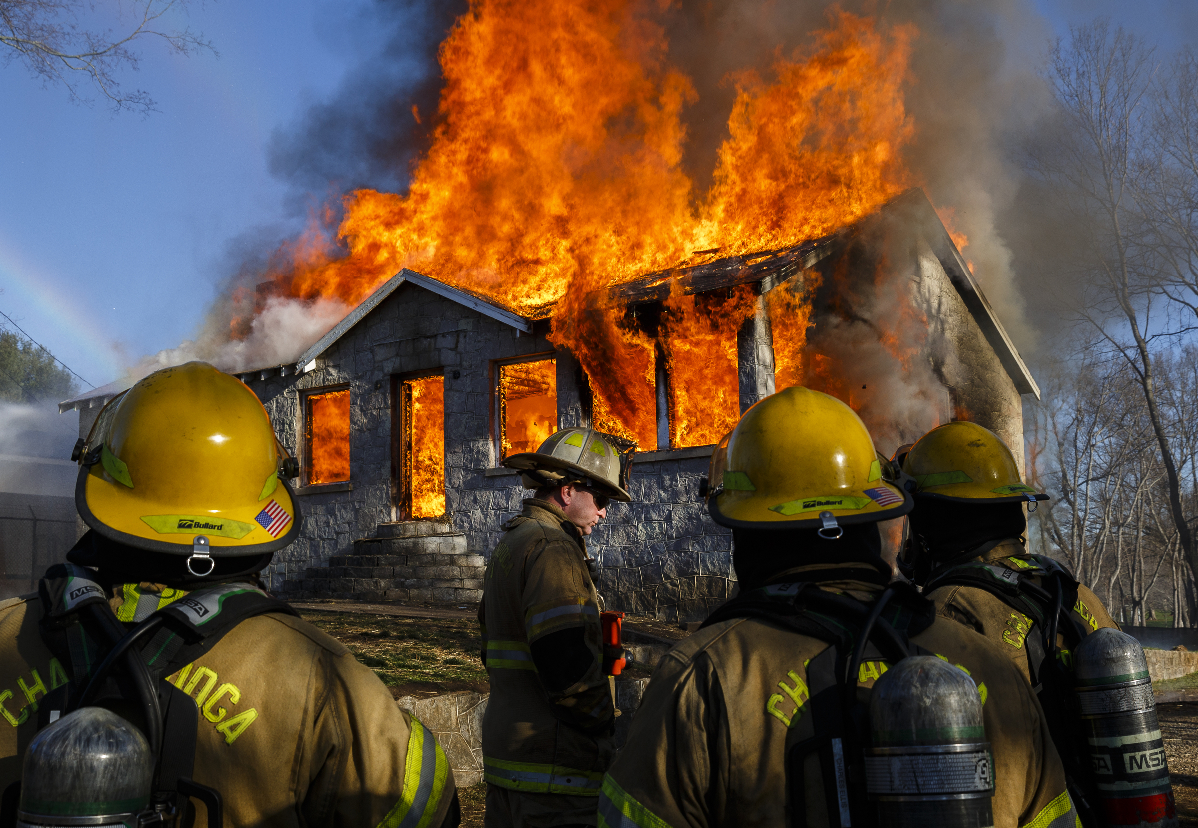 Firefighters watch as the vacant structure becomes fully engulfed at a live burn training event by the Chattanooga Fire Department on Robin Drive on Thursday, Feb. 16, 2017, in Chattanooga, Tenn. The fire department uses live burns as part of their fire academy training, culminating in the complete immolation of a structure.