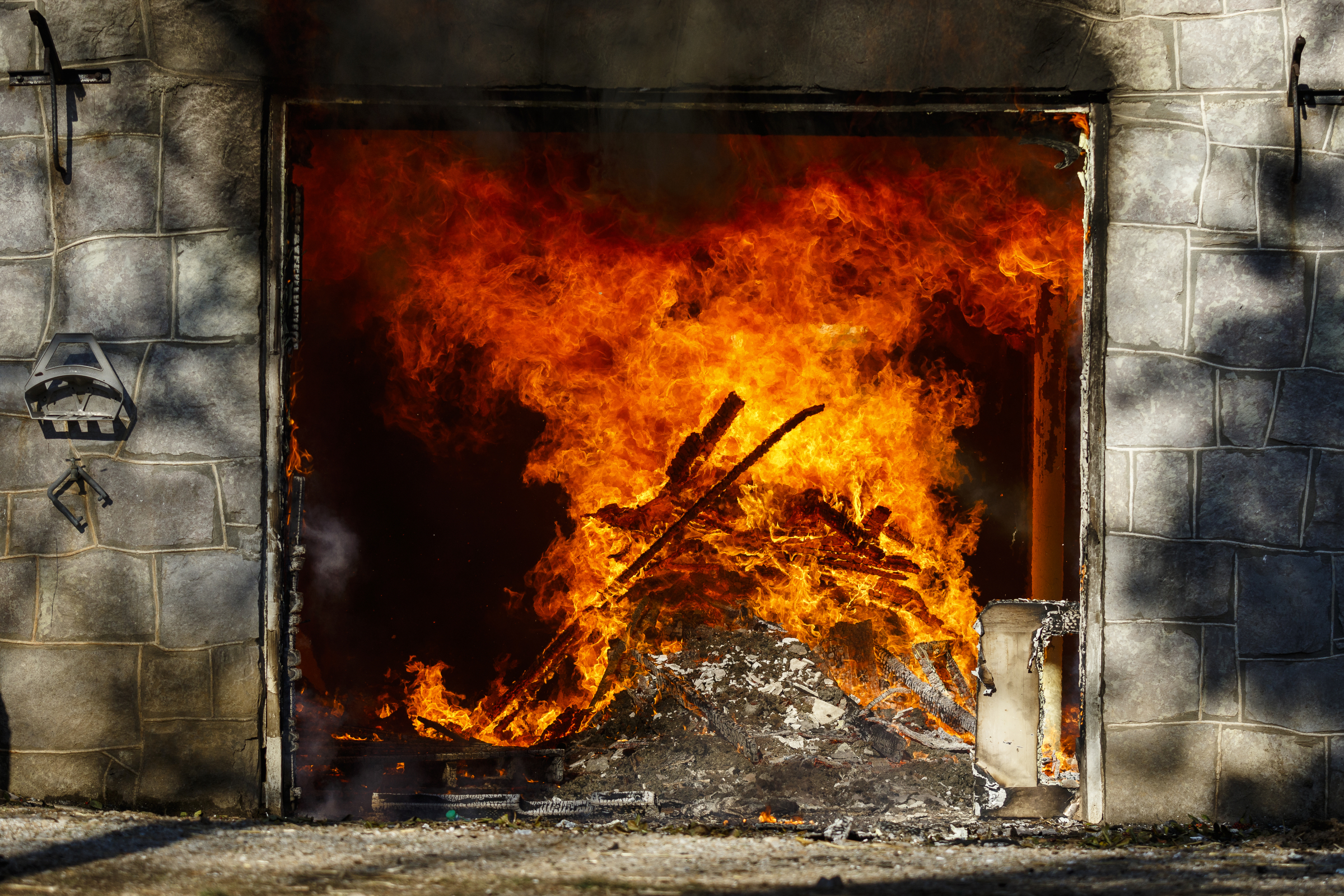 Kindling in the basement of the structure burns at a live burn training event by the Chattanooga Fire Department on Robin Drive on Thursday, Feb. 16, 2017, in Chattanooga, Tenn. The fire department uses live burns as part of their fire academy training, culminating in the complete immolation of a structure.