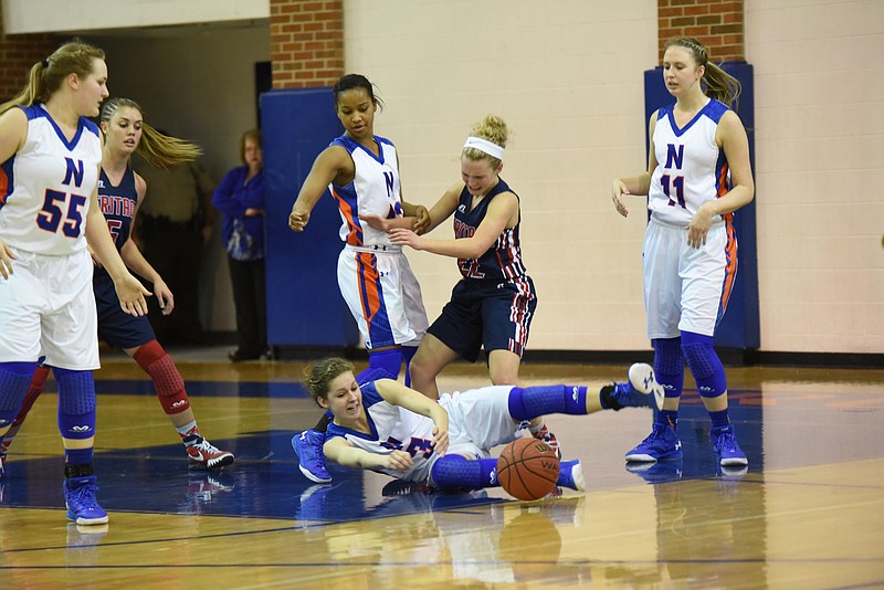 Northwest Whitfield's Lindsey Robert (3) looks for control on the floor as Bria Clemmons, left, collides with Heritage's Jenny Grant (22) in first half action.