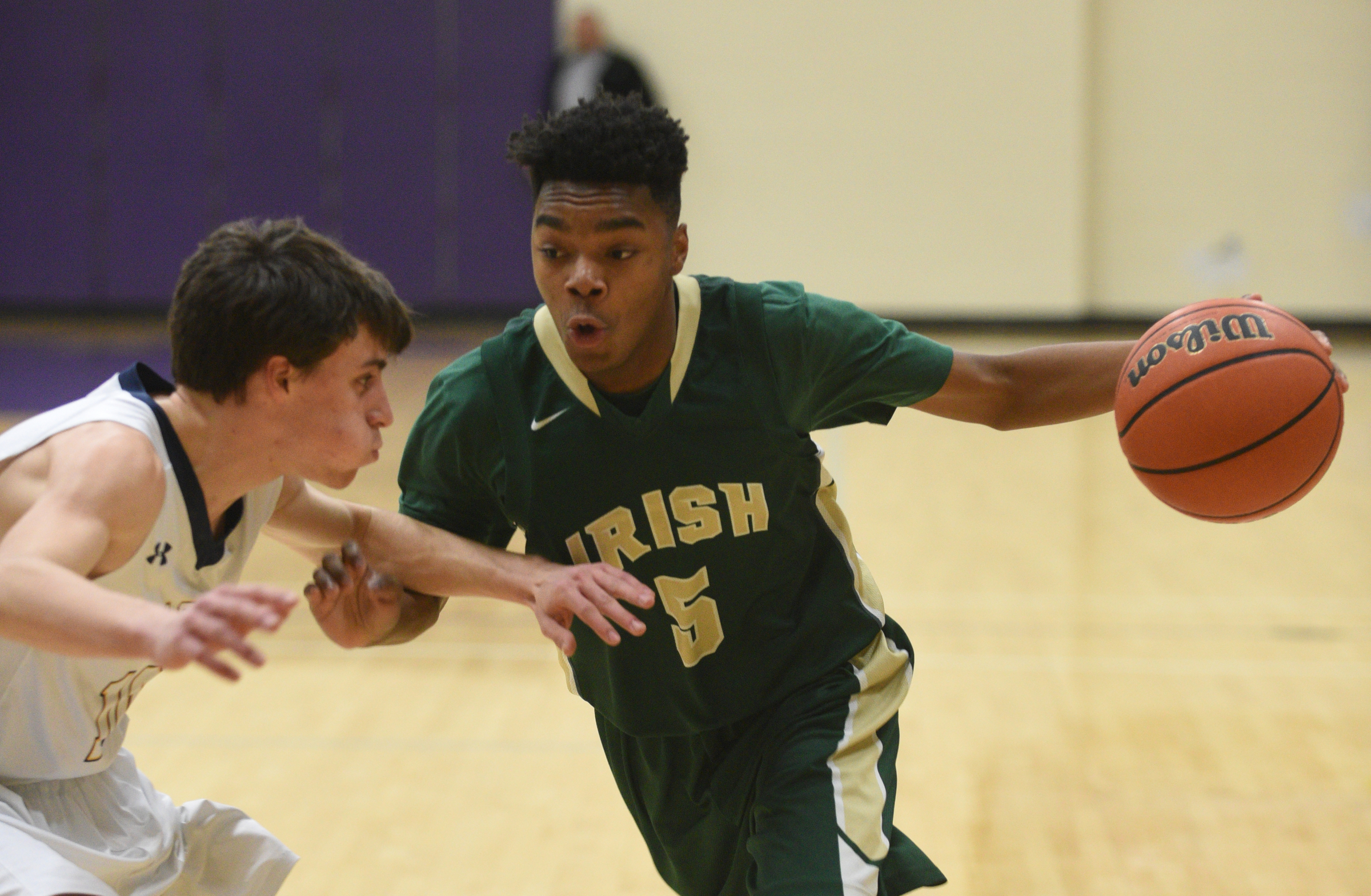 Notre Dame's Nolan Corbitt is guarded by Chattanooga Christian's Ryan Rhodes during the Irish's 65-52 District 7-AA semifinal victory Thursday at Sequatchie County High School.