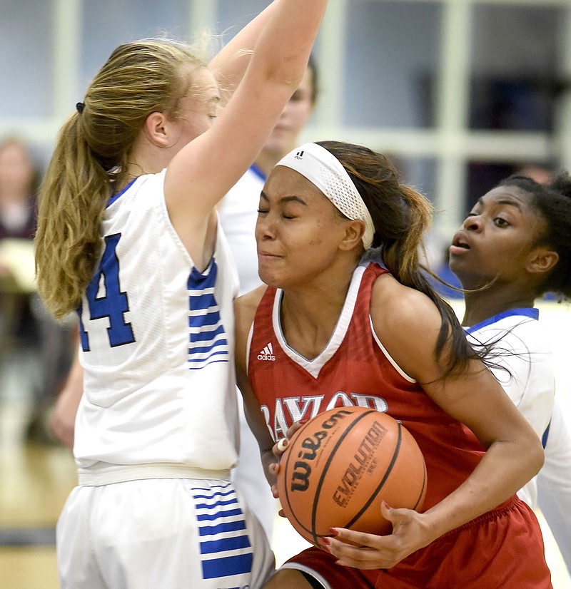 Baylor's Mya Long (20) collides with GPS's Mackenzie Jennings (14).  Jennings was called for blocking on the play.  The Baylor Red Raiders visited the GPS Bruisers in TSSAA basketball action on January 26, 2017.  