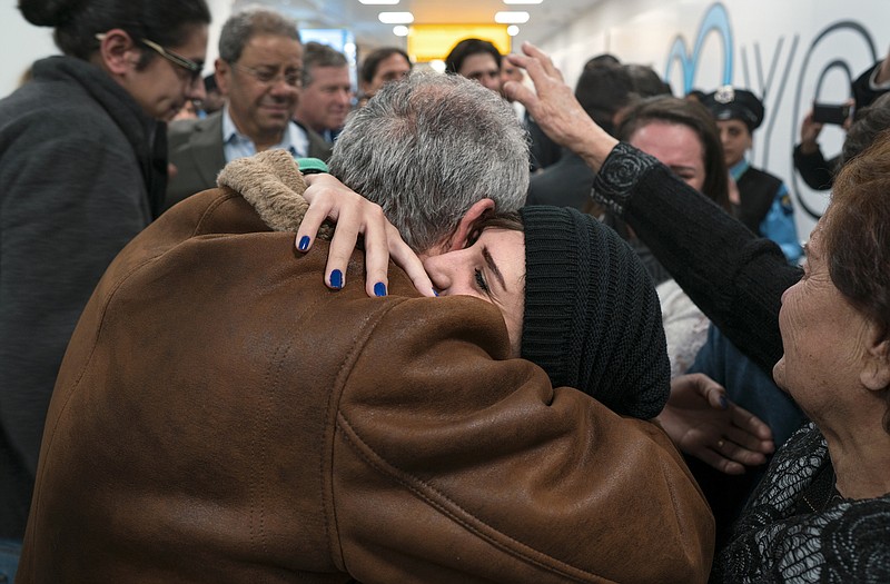 
              FILE - In a Monday, Feb. 6, 2017 file photo, family members who have just arrived from Syria embrace and are greeted by family who live in the United States upon their arrival at John F. Kennedy International Airport in New York. Organizers in cities across the U.S. are telling immigrants to miss class, miss work and not shop on Thursday, Feb. 16, 2017,  as a way to show the country how important they are to America's economy and way of life. "A Day Without Immigrants" actions are planned in cities including Philadelphia, Washington, Boston and Austin, Texas. (AP Photo/Craig Ruttle)
            