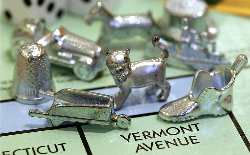 
              FILE - In this Feb. 5, 2013 file photo, the thimble game piece, left, sits among other Monopoly tokens at Hasbro Inc., headquarters in Pawtucket, R.I. The thimble will no longer be a game piece in Monopoly, rejected in 2017 in a campaign to determine the tokens for the next generation of the game. (AP Photo/Steven Senne, File)
            