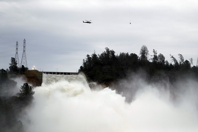 Water gushes down the Oroville Dam's main spillway Wednesday, Feb. 15, 2017, in Oroville, Calif. The Oroville Reservoir is continuing to drain Wednesday as state water officials scrambled to reduce the lake's level ahead of impending storms. (AP Photo/Marcio Jose Sanchez)