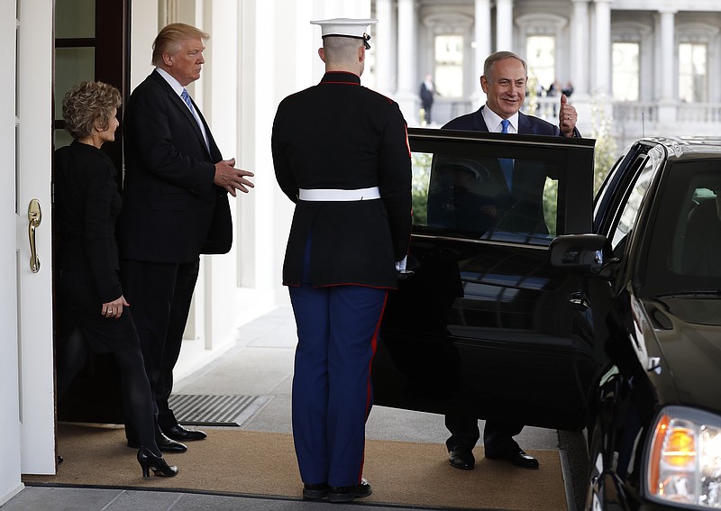 
              Israeli Prime Minister Benjamin Netanyahu gives the thumbs-up as he is escorted to his car by President Donald Trump as he leaves the West Wing of the White House in Washington, Wednesday, Feb. 15, 2017. (AP Photo/Carolyn Kaster)
            