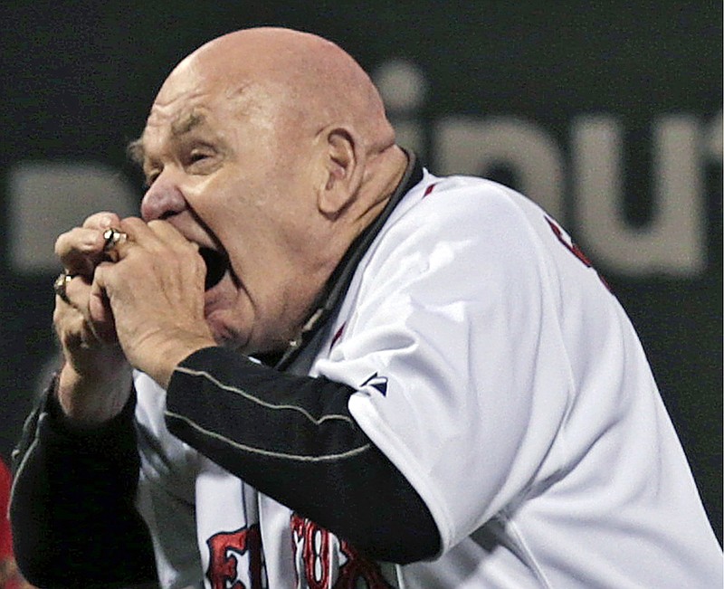 
              FILE - In this Sept. 21, 2012, file photo, former professional wrestler George "The Animal" Steele bites the baseball before throwing out the ceremonial first pitch before a baseball game between the Baltimore Orioles and Boston Red Sox at Fenway Park in Boston. WWE Hall of Fame member George "The Animal" Steele, whose given name was Jim Myers, has died at age 79, the WWE announced Friday, Feb. 17, 2017. (AP Photo/Charles Krupa, File)
            