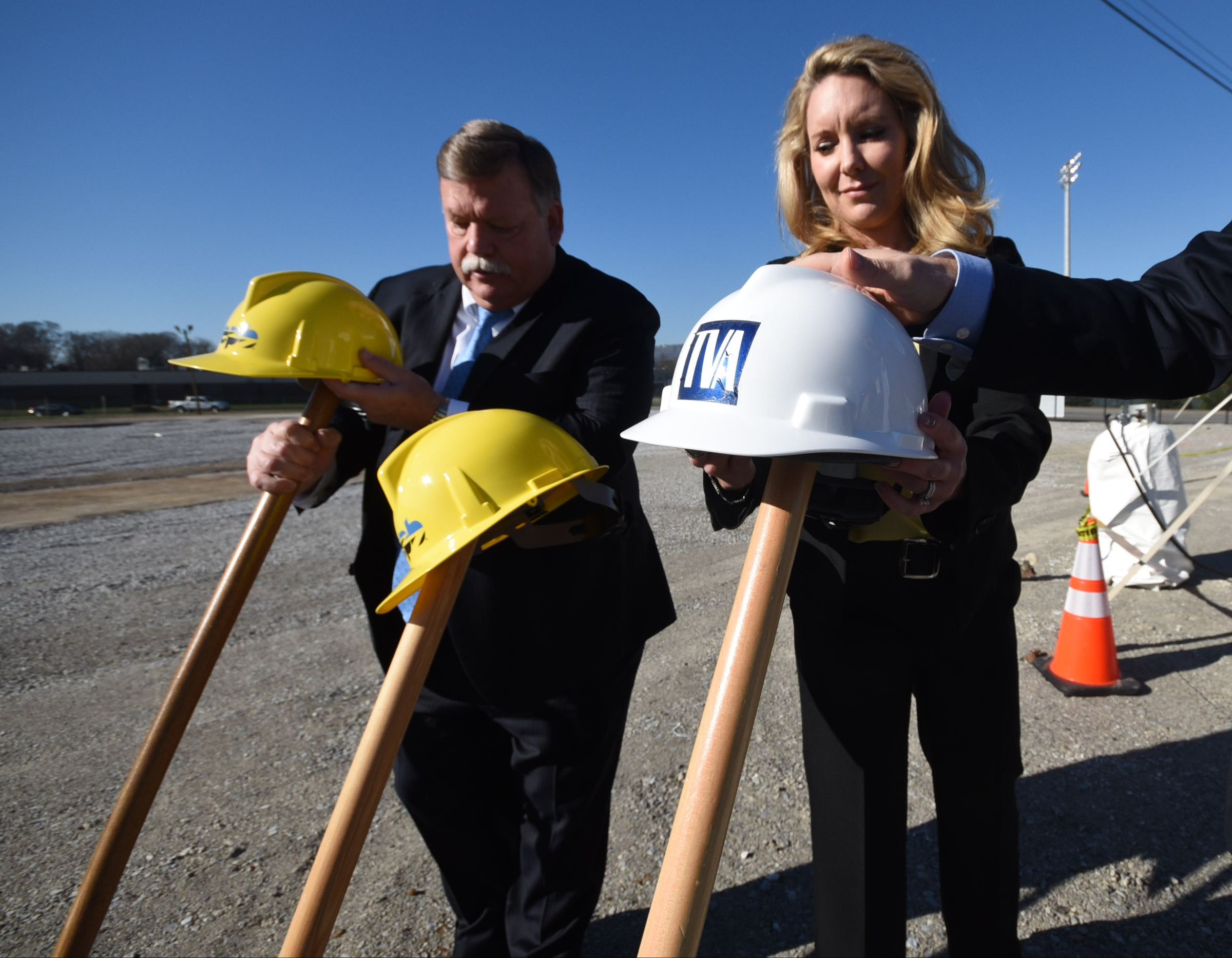 Hamilton County Mayor Jim Coppinger, left, and Nancy Mitchell, TVA General Manager for Customer Delivery Southeast, hang their hats Friday morning following a breakgrounding for a 4.5-acre solar garden facing Holtzclaw Avenue, across from the Chattanooga Zoo.