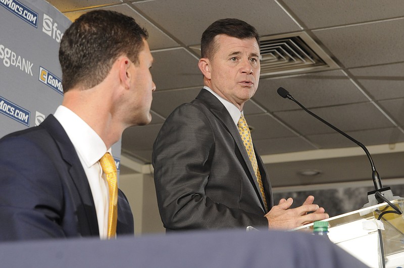 David Blackburn, UTC Athletic Director, talks about new Chattanooga Mocs Head Coach Tom Arth, near left, before a crowd of fans, media and a few attending players inside the Stadium Club at Finley Stadium.